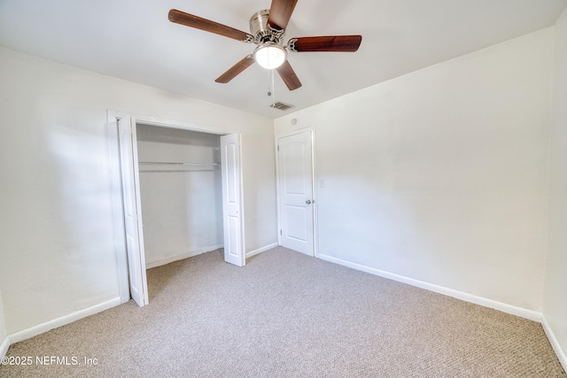 unfurnished bedroom with light colored carpet, ceiling fan, and a closet