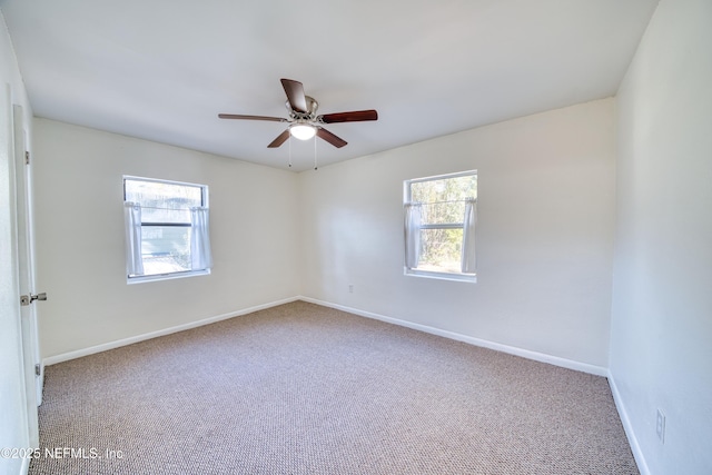 empty room with ceiling fan and carpet