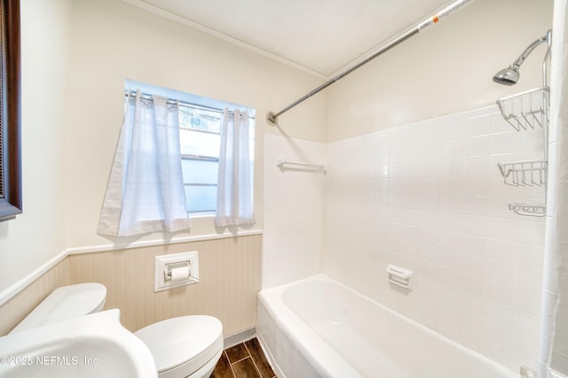 full bathroom featuring crown molding, toilet, tiled shower / bath combo, and sink