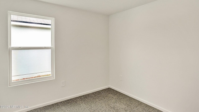 empty room with carpet flooring and plenty of natural light