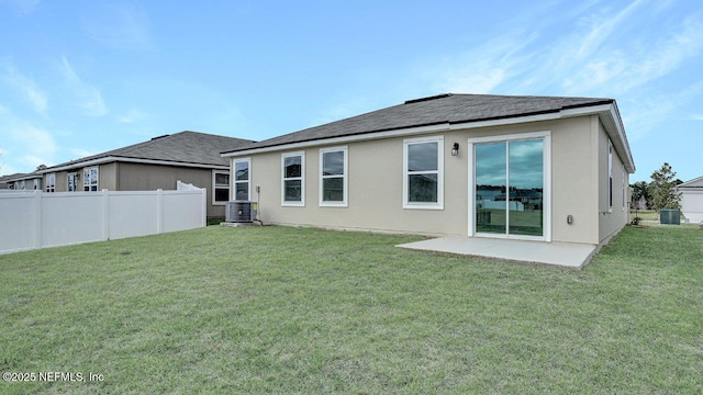 back of house featuring a yard, a patio, and central air condition unit