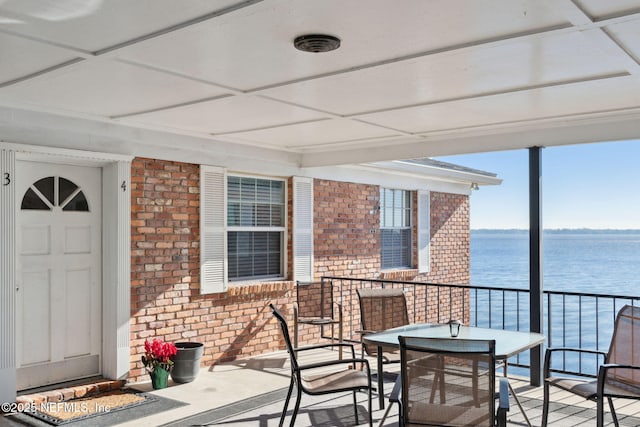 exterior space featuring a water view and a balcony