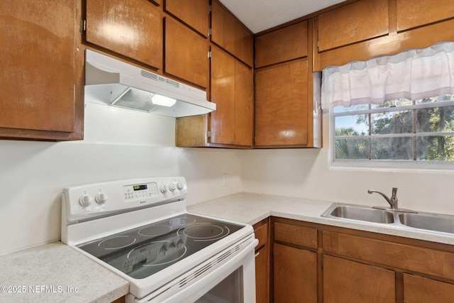 kitchen featuring white range with electric cooktop and sink