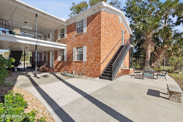 back of property with a patio area and a balcony