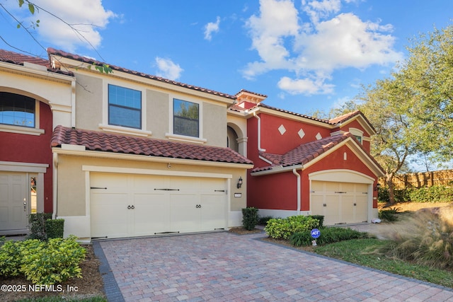 mediterranean / spanish-style home with a garage