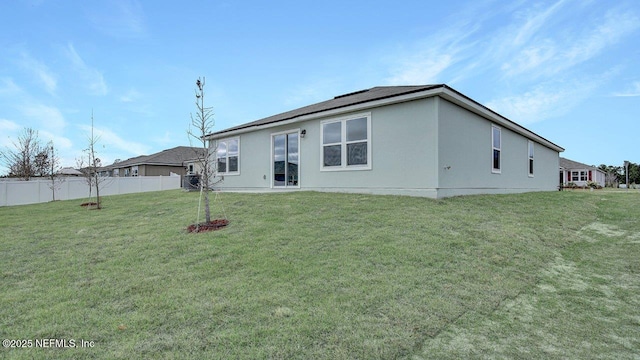 rear view of house featuring a yard