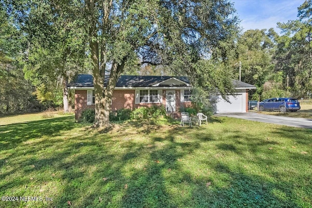 ranch-style home featuring a front yard and a garage