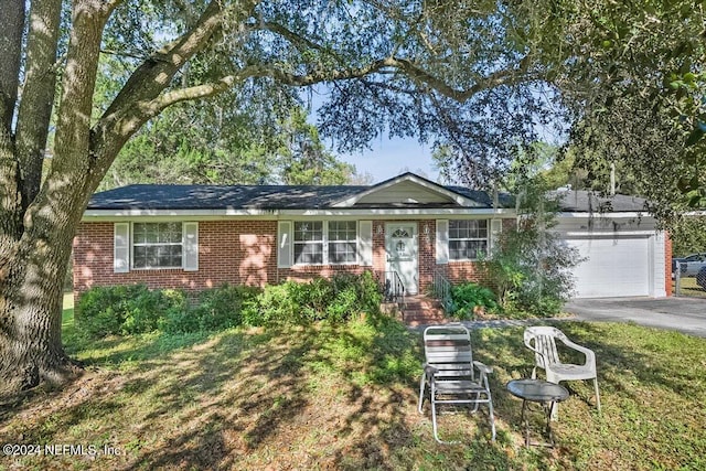 single story home featuring a front yard and a garage