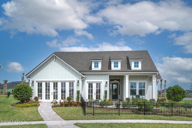 view of front of property with french doors and a front lawn