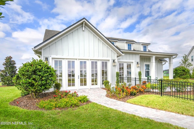 view of front of property with a front yard and french doors