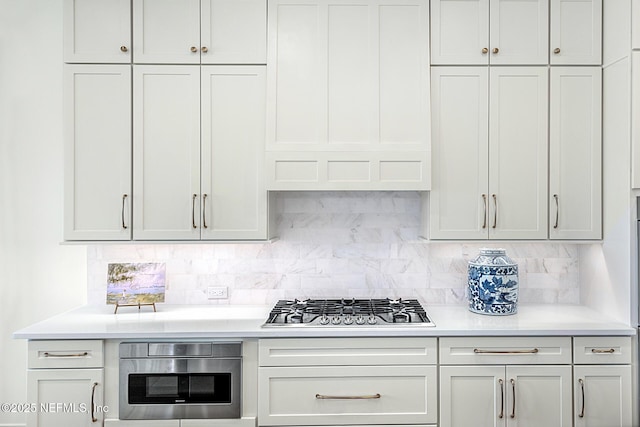 kitchen featuring tasteful backsplash, oven, and stainless steel gas cooktop