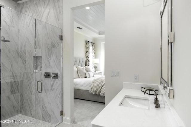 bathroom featuring a shower with door and vanity