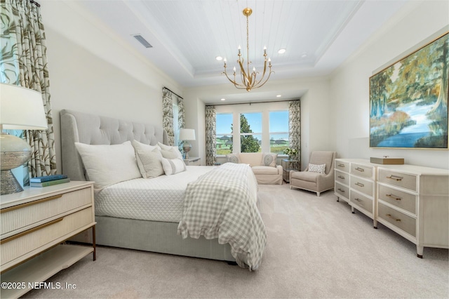 bedroom with a notable chandelier, light colored carpet, and a tray ceiling