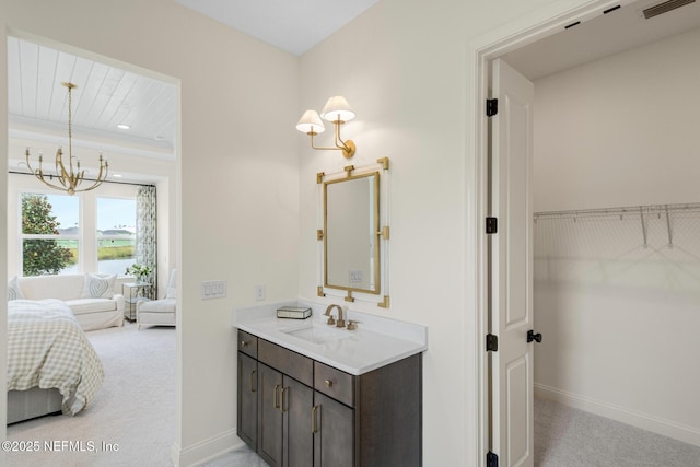 bathroom featuring vanity, an inviting chandelier, and wood ceiling