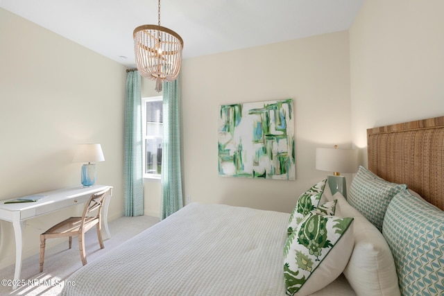 carpeted bedroom with a chandelier