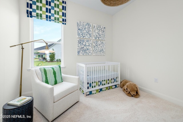 carpeted bedroom with a nursery area