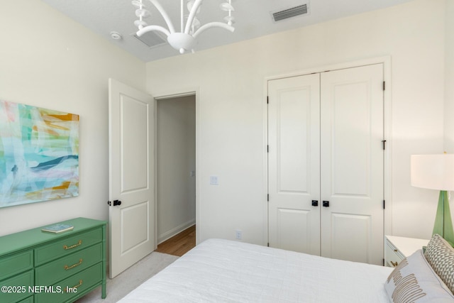 bedroom with an inviting chandelier and a closet