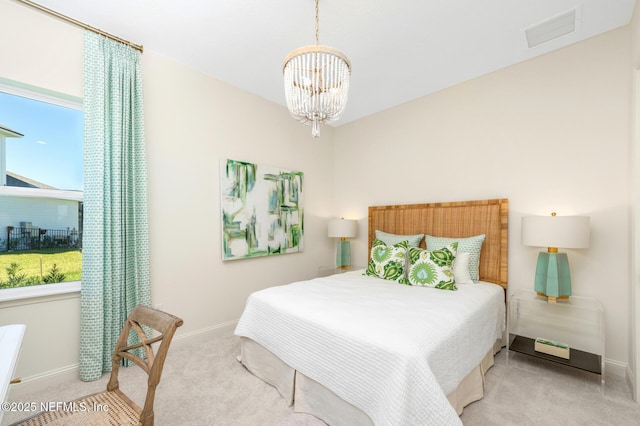 carpeted bedroom featuring a notable chandelier