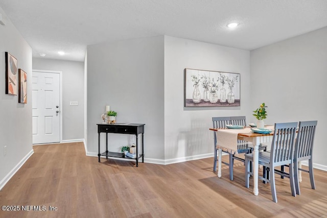 dining space featuring light wood-type flooring