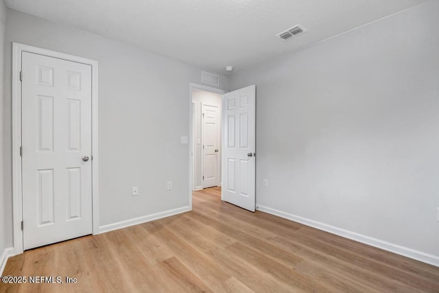 unfurnished bedroom with light wood-type flooring