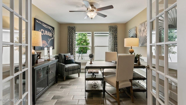 sitting room with ceiling fan and french doors