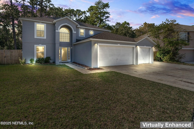 view of front property with a garage and a lawn