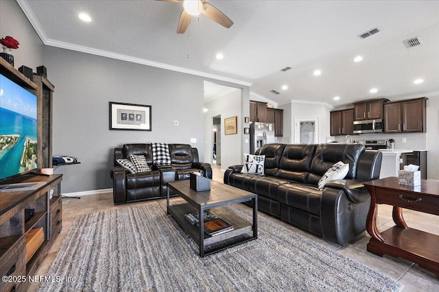 tiled living room featuring ceiling fan and crown molding