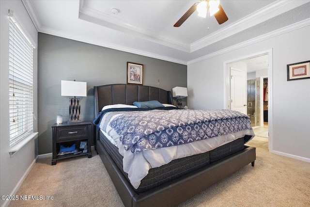 carpeted bedroom featuring a raised ceiling, ceiling fan, and crown molding