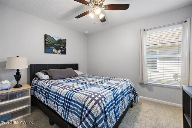 bedroom with multiple windows, ceiling fan, and carpet