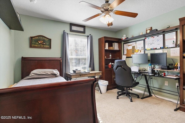 carpeted bedroom with a textured ceiling and ceiling fan