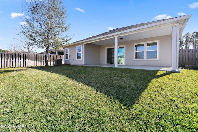 back of house featuring a patio, a yard, and central AC unit