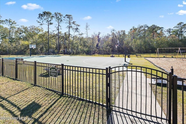 view of basketball court with a lawn