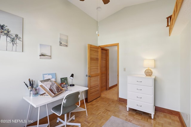 home office featuring ceiling fan, vaulted ceiling, and light parquet flooring