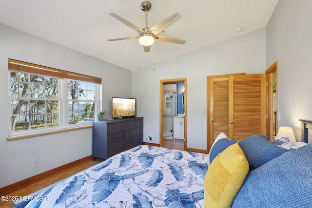 bedroom with connected bathroom, wood-type flooring, vaulted ceiling, a closet, and ceiling fan