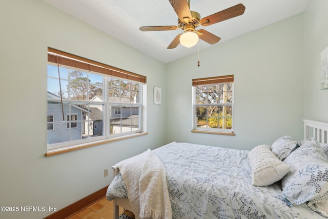 bedroom featuring parquet floors and ceiling fan