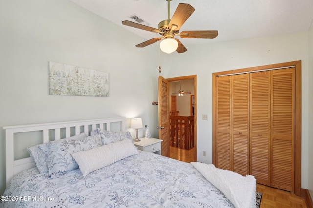 bedroom featuring parquet flooring, a closet, ceiling fan, and vaulted ceiling