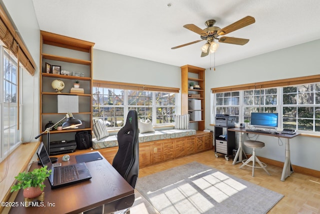 office space featuring ceiling fan and light parquet flooring