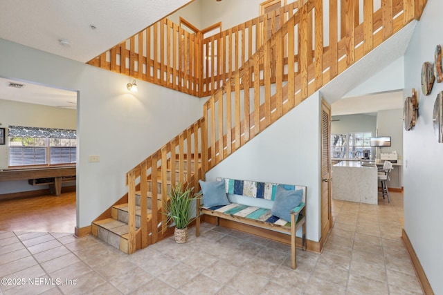 stairs featuring tile patterned flooring