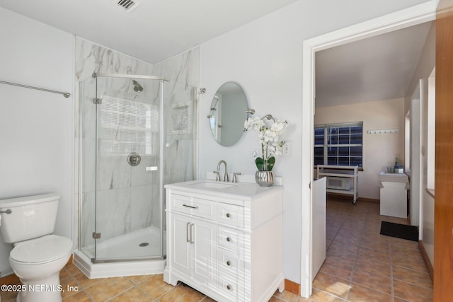 bathroom featuring walk in shower, tile patterned floors, toilet, and vanity