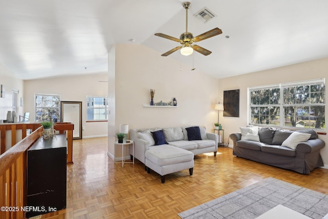 living room featuring ceiling fan, vaulted ceiling, and light parquet floors