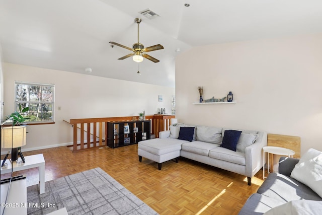 living room featuring light parquet floors, vaulted ceiling, and ceiling fan