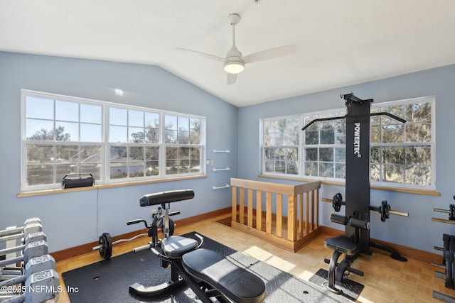 exercise area with ceiling fan, vaulted ceiling, and light parquet floors