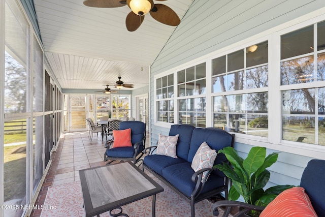 sunroom featuring vaulted ceiling