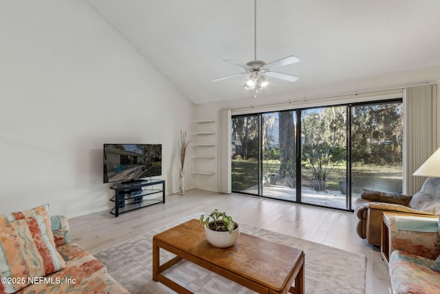 living room with ceiling fan, light hardwood / wood-style floors, and lofted ceiling