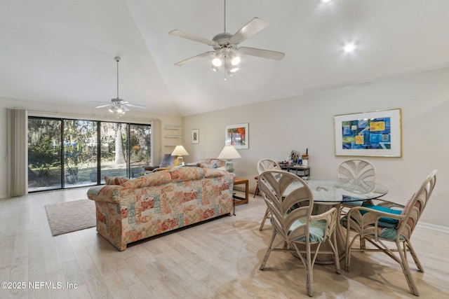 living room with light hardwood / wood-style floors, high vaulted ceiling, and ceiling fan