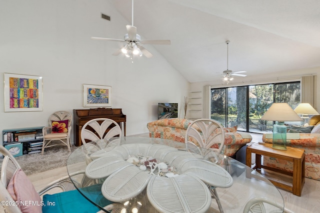 dining space featuring ceiling fan and lofted ceiling