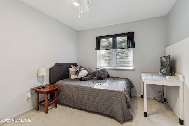 bedroom with ceiling fan and light carpet