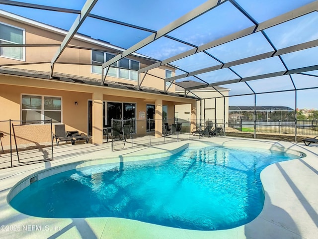 view of swimming pool featuring a patio area and a lanai