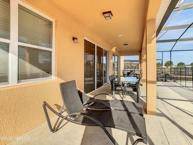 view of patio / terrace featuring a lanai