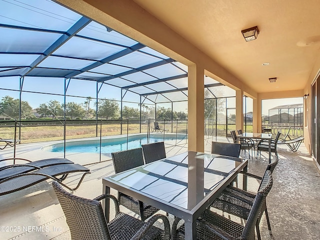 view of patio featuring glass enclosure